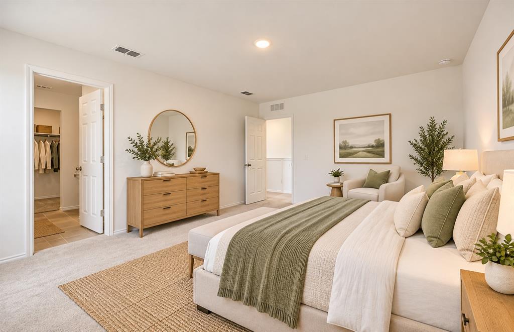 Neutral-toned carpet, recessed lighting, and a walk-in closet with interior shelving