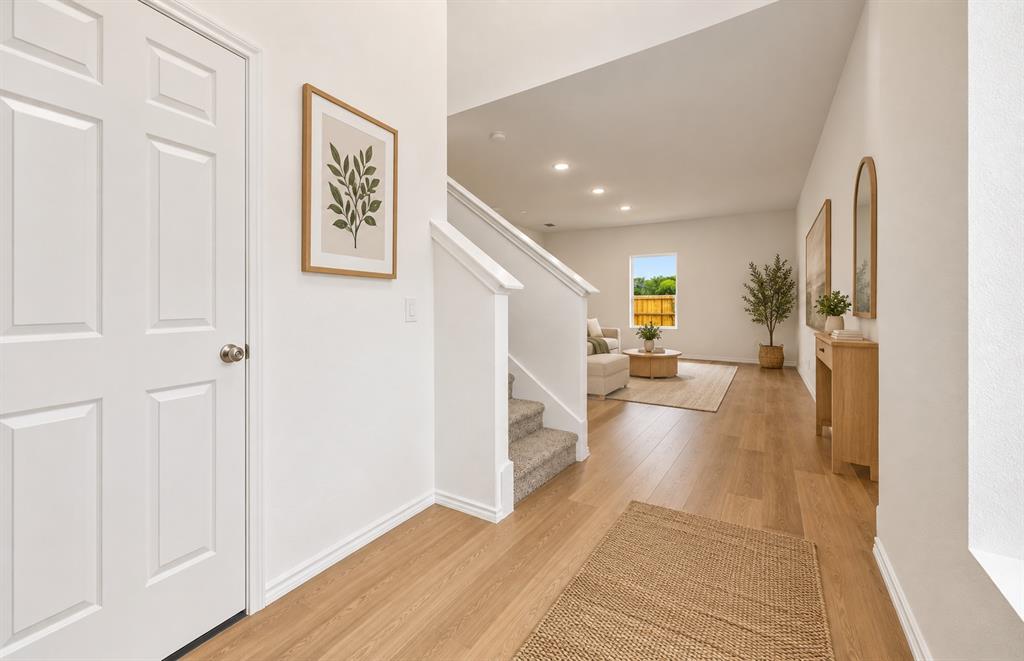 Entryway featuring wood-finish flooring, recessed lighting, and a staircase with neutral carpeting