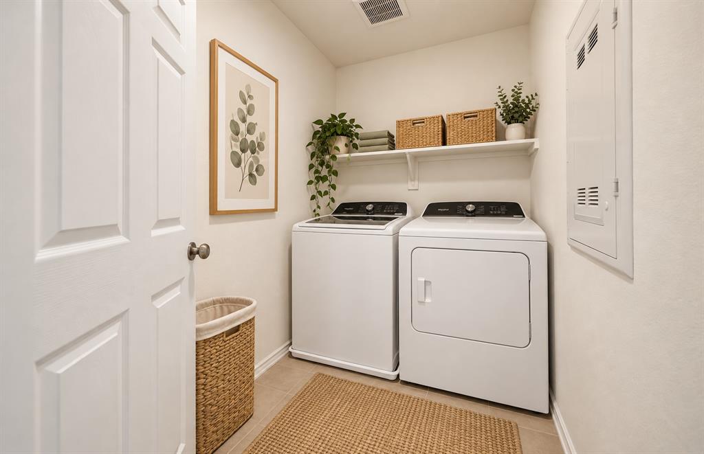 Laundry area featuring tile flooring, a wall-mounted shelving unit, and a recessed electrical service panel