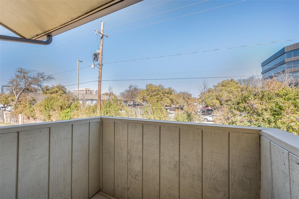 Covered balcony featuring vertical wood-paneled walls and an overhead overhang