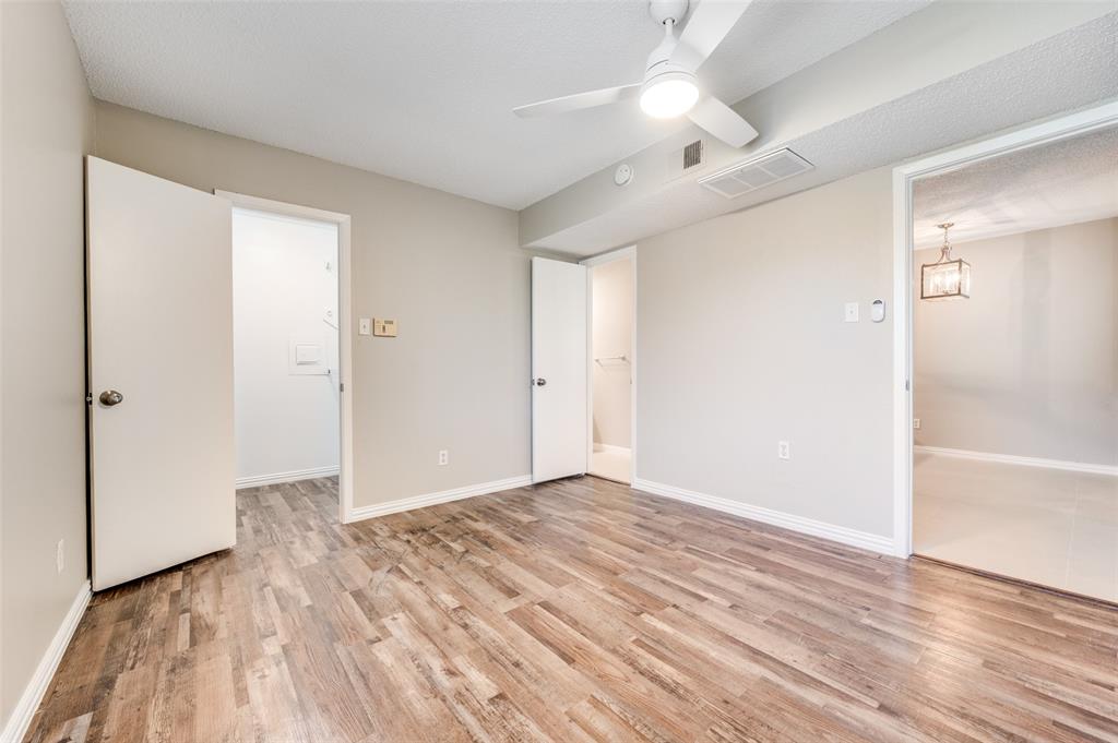 Interior room featuring Wood-look luxury vinyl planks (LVP)  a ceiling fan with integrated lighting, and neutral wall tones