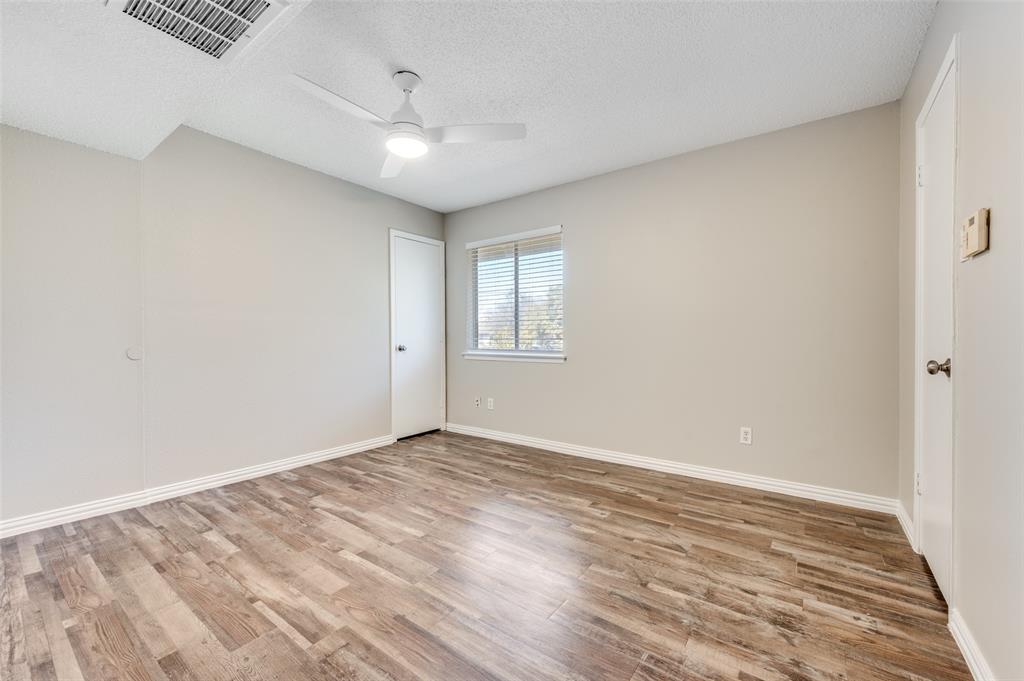 Room featuring Wood-look luxury vinyl planks (LVP)  a white ceiling fan with integrated lighting, and a single window with horizontal blinds
