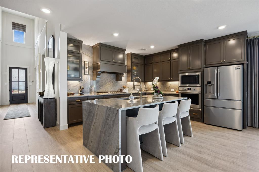 Featuring outstanding storage and prep space, the chef in the family will fall in love with this dream kitchen!  REPRESENTATIVE PHOTO