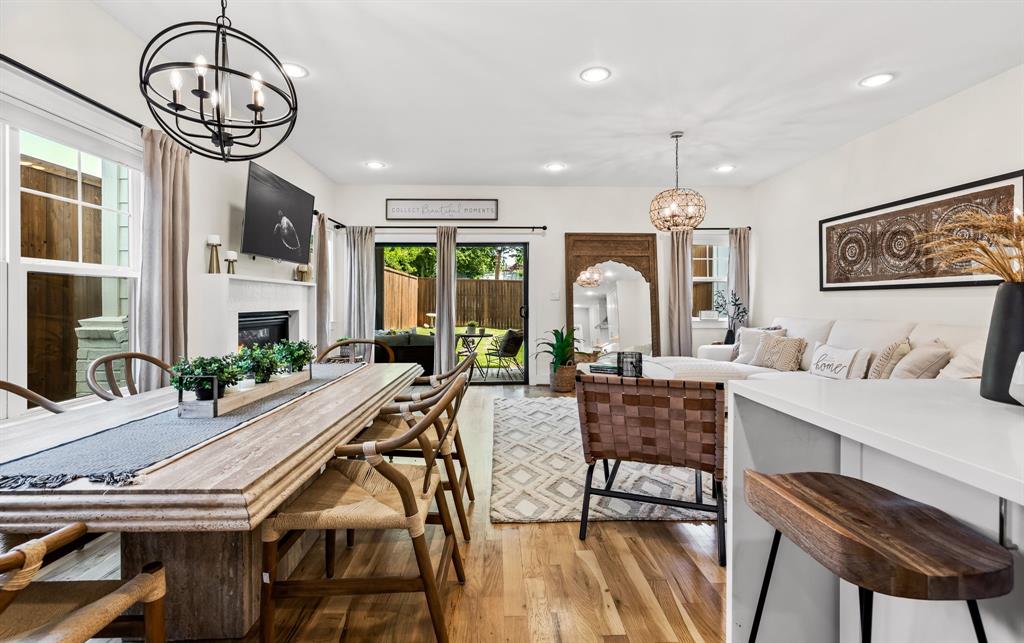 Dining space with hardwood / wood-style flooring and a chandelier