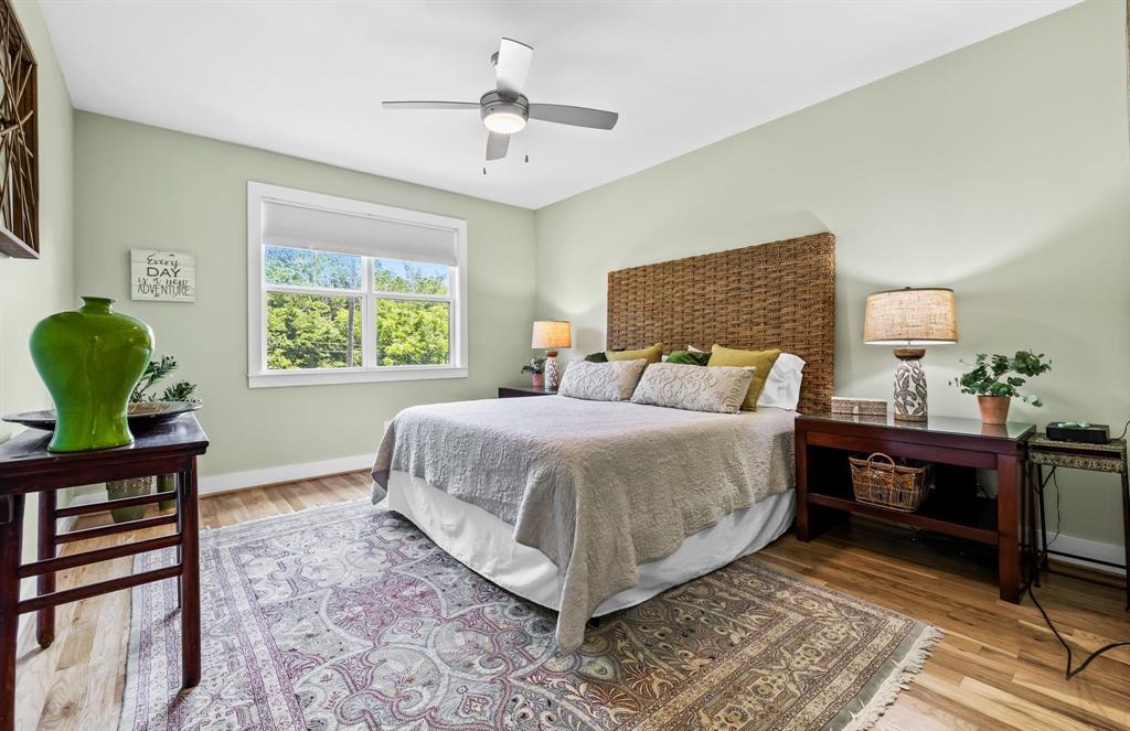Bedroom with ceiling fan and hardwood / wood-style flooring