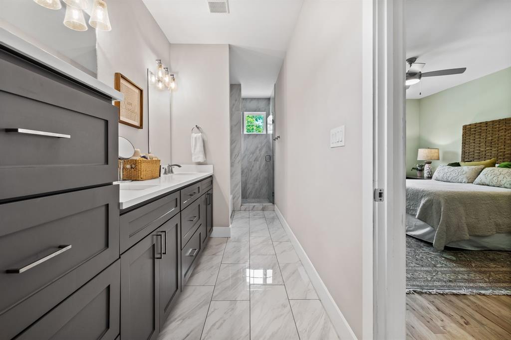 Bathroom with ceiling fan, tile flooring, and double vanity