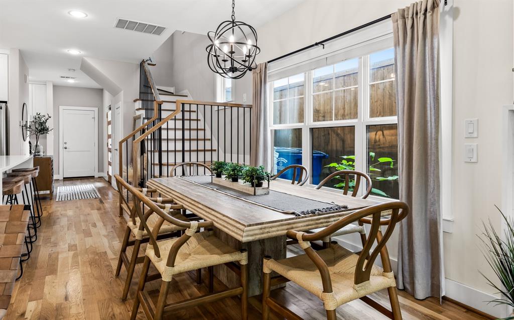 Dining area featuring a notable chandelier and light hardwood / wood-style floors