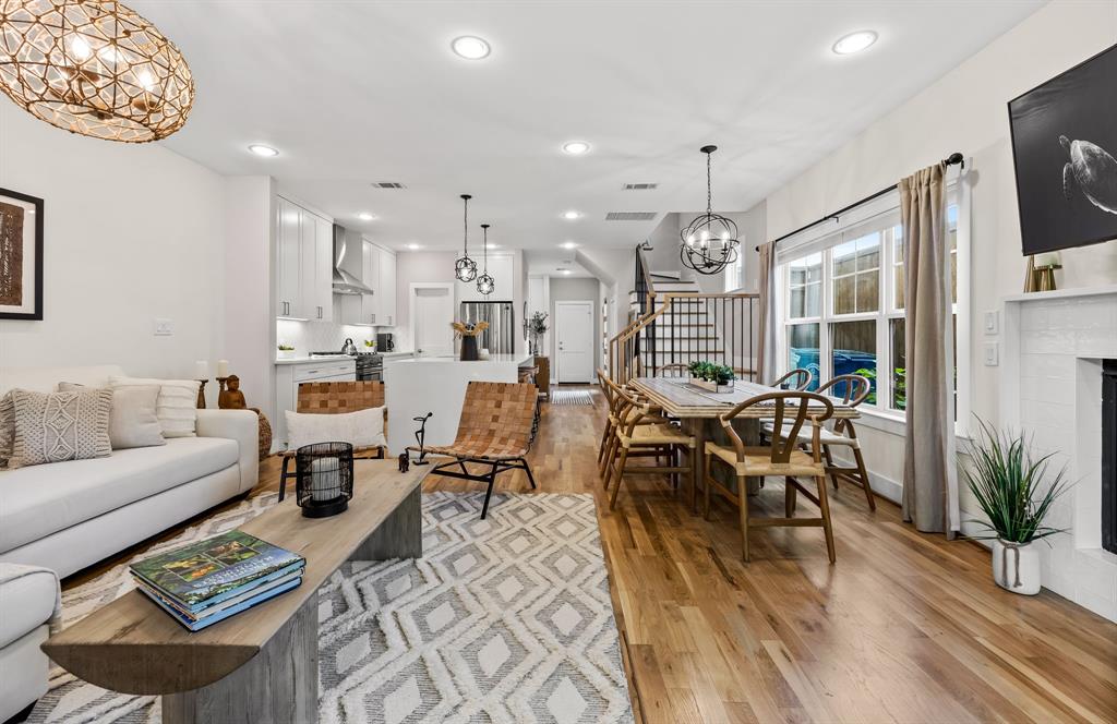 Living room with an inviting chandelier, light hardwood / wood-st