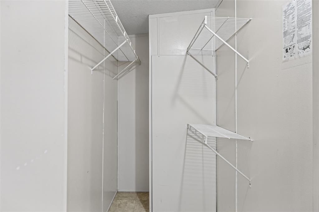 Storage space featuring white wall-mounted wire shelving units