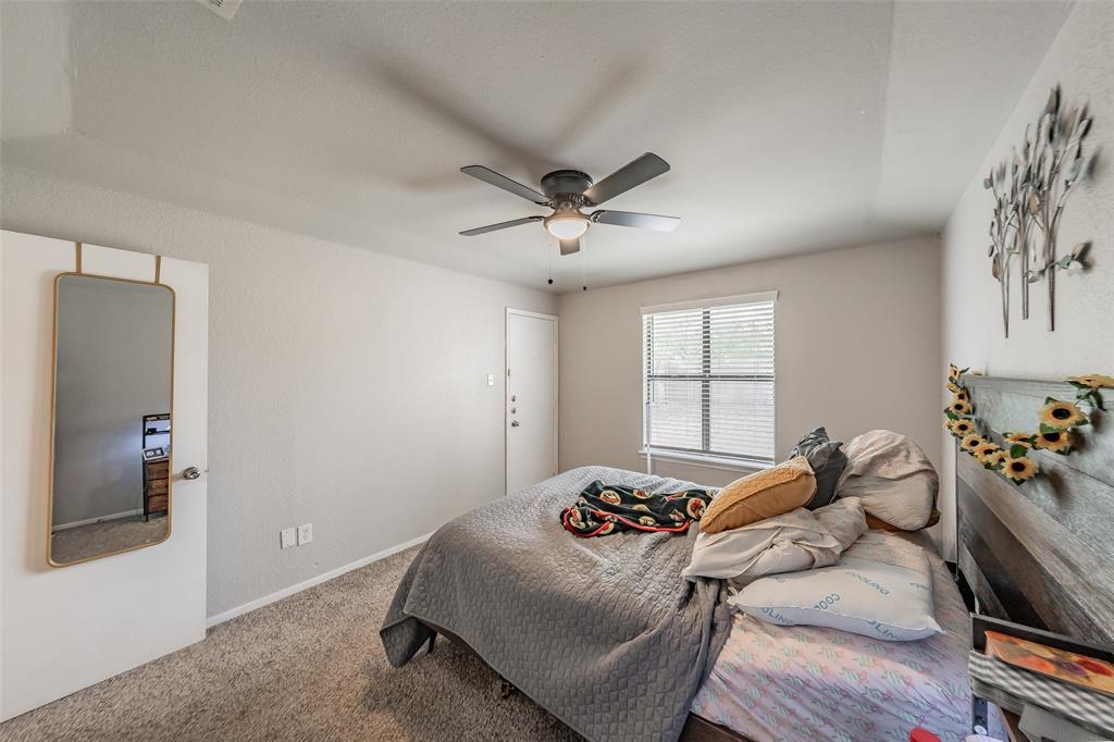 1126 Neutral-toned bedroom featuring wall-to-wall carpeting, a ceiling fan with integrated lighting, and a single window with horizontal blinds