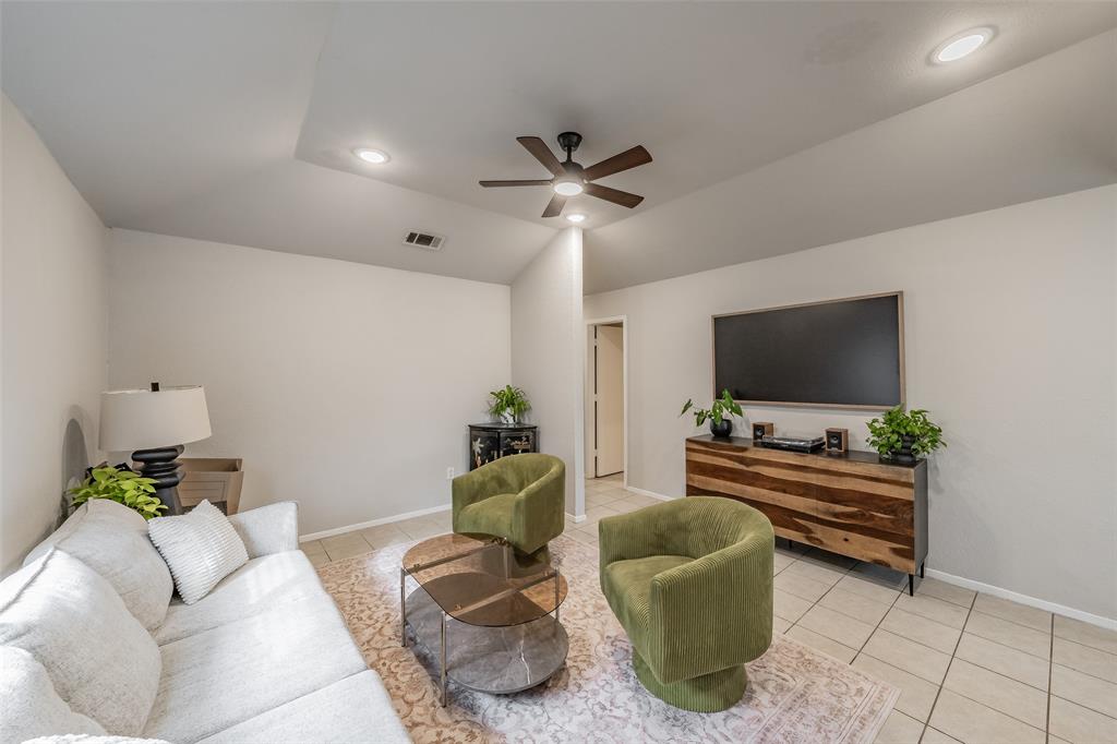 1128 Vaulted ceiling featuring recessed lighting and a central ceiling fan, paired with neutral-toned ceramic tile flooring 1128 Vaulted ceiling featuring recessed lighting and a central ceiling fan, paired with neutral-toned ceramic tile flooring