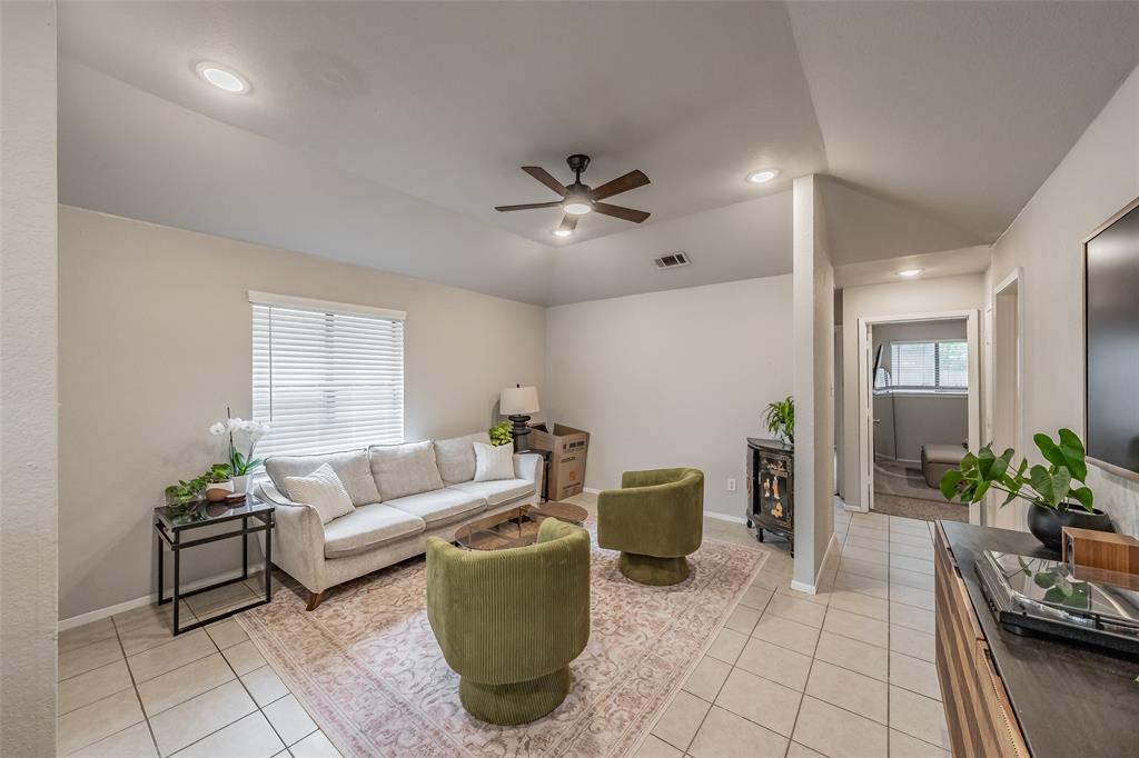 1128 Vaulted ceiling with recessed lighting and a central ceiling fan, neutral wall paint, and large-format tile flooring 1128 Vaulted ceiling with recessed lighting and a central ceiling fan, neutral wall paint, and large-format tile flooring