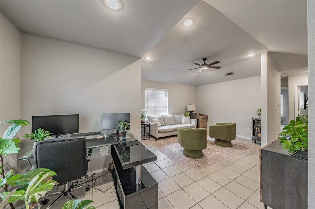1128 Open-concept interior featuring vaulted ceilings, recessed lighting, tile flooring, and a ceiling fan