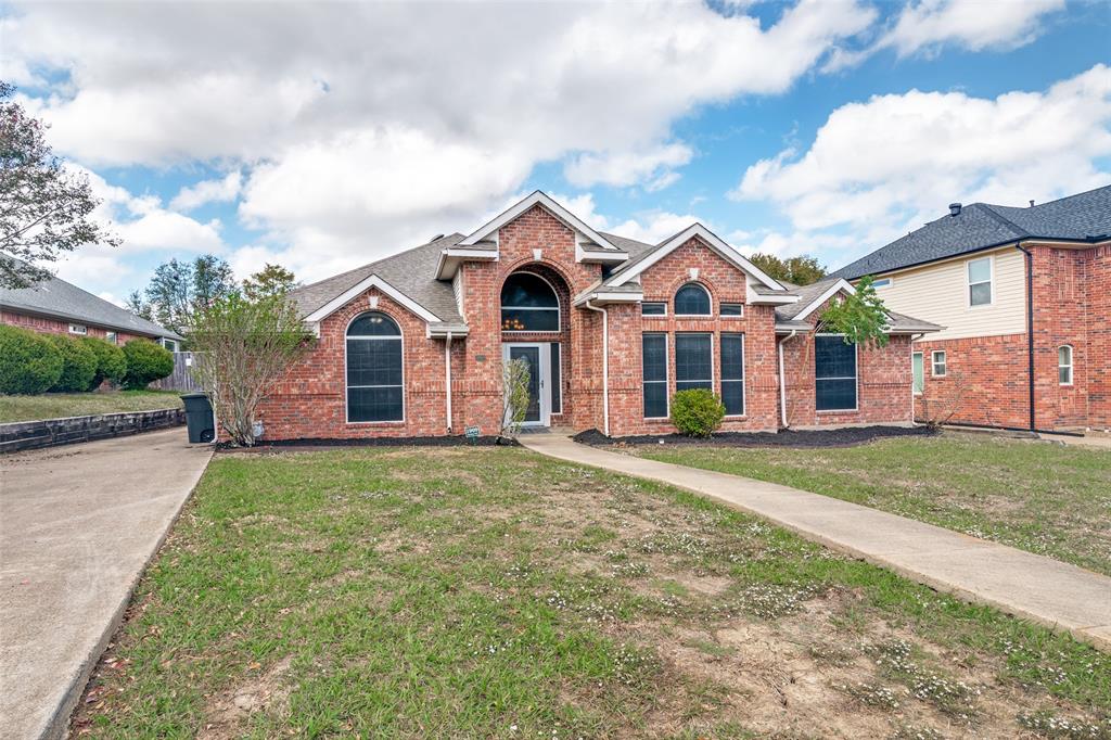 Brick exterior featuring a gabled roofline, arched window accents, and a covered entryway Brick exterior featuring a gabled roofline, arched window accents, and a covered entryway