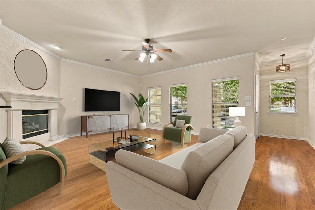 Beautiful living room with warm wood floors and a cozy fireplace operated by a convenient wall switch. Perfect for relaxing evenings or gathering with friends. Virtual Staging.