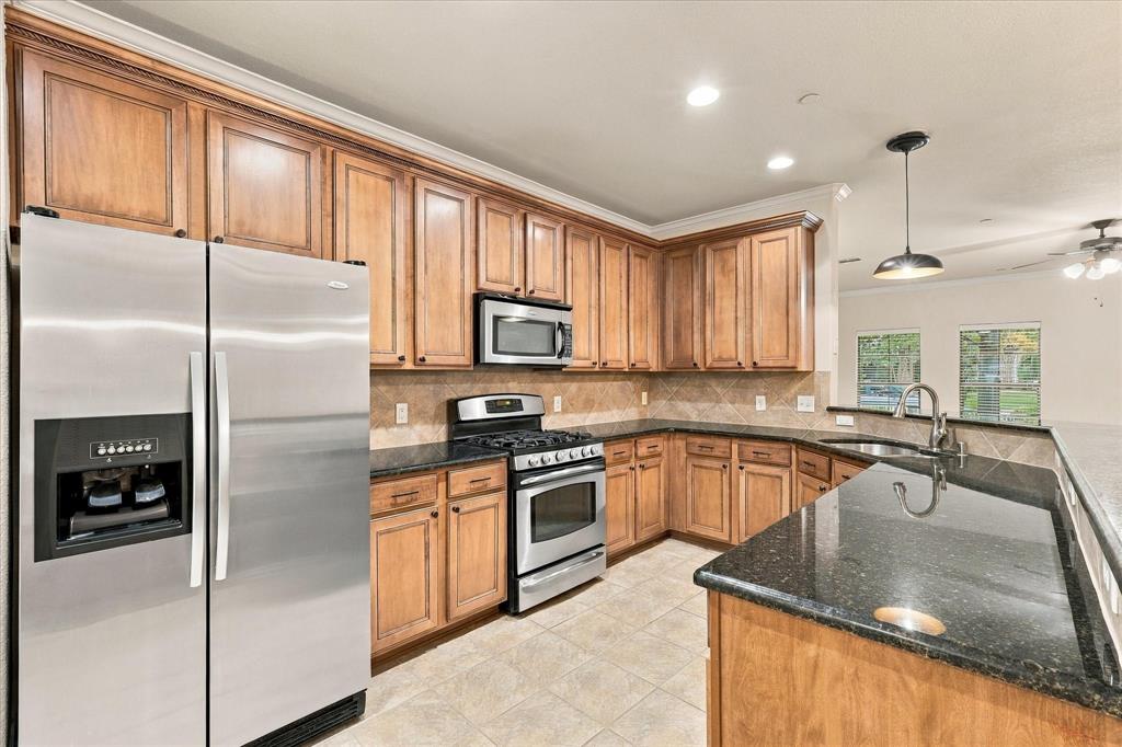 Abundant cabinetry, granite countertops, stainless steel appliances, and a generous serving bar to create all of your culinary delights.
