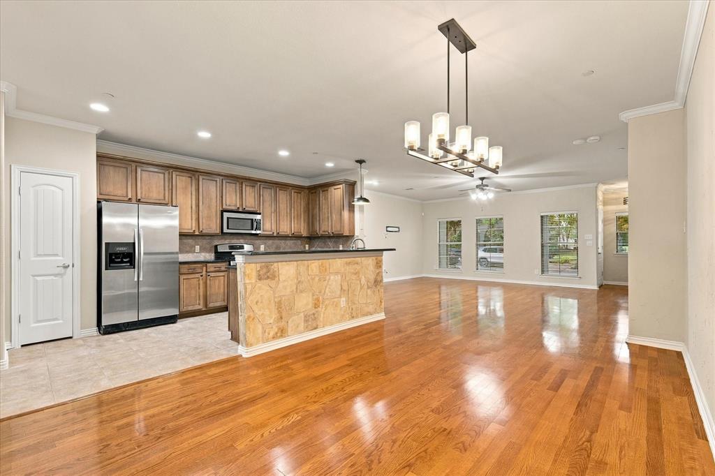 Rich wood floors and an expansive layout offer a blank canvas to make this home uniquely yours. TV wall mount remains for added convenience.