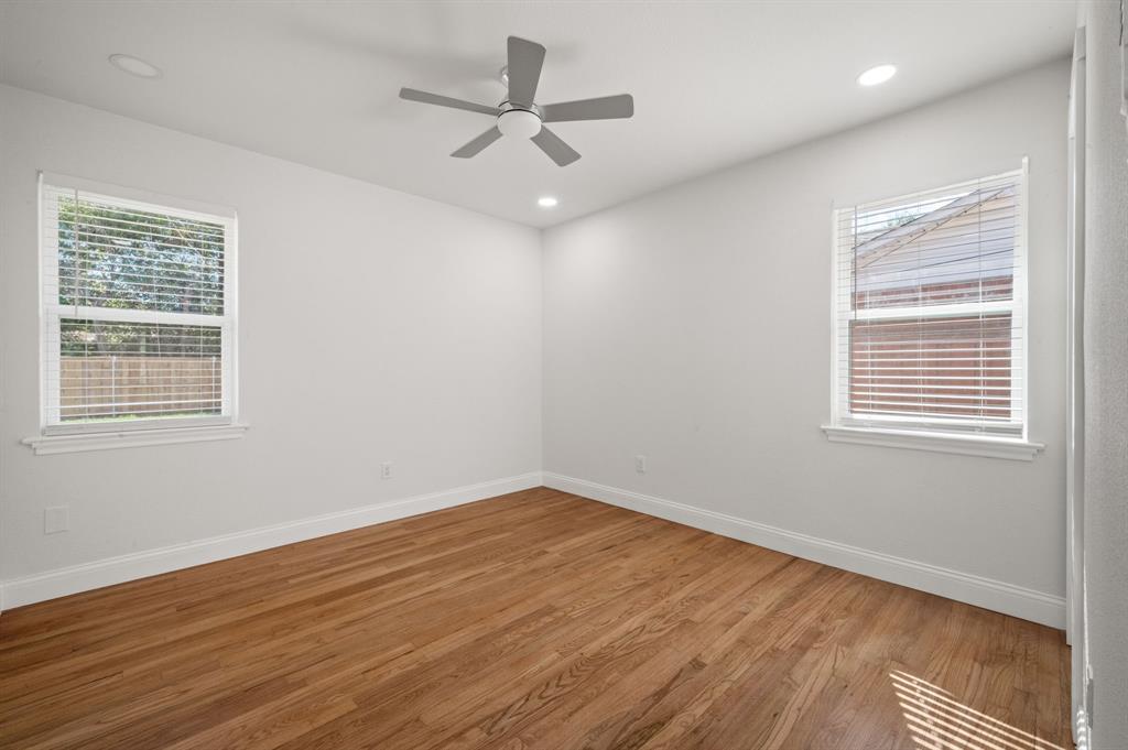 Interior space featuring wood-finish flooring, neutral walls, recessed lighting, and a centrally mounted ceiling fan with double-pane windows