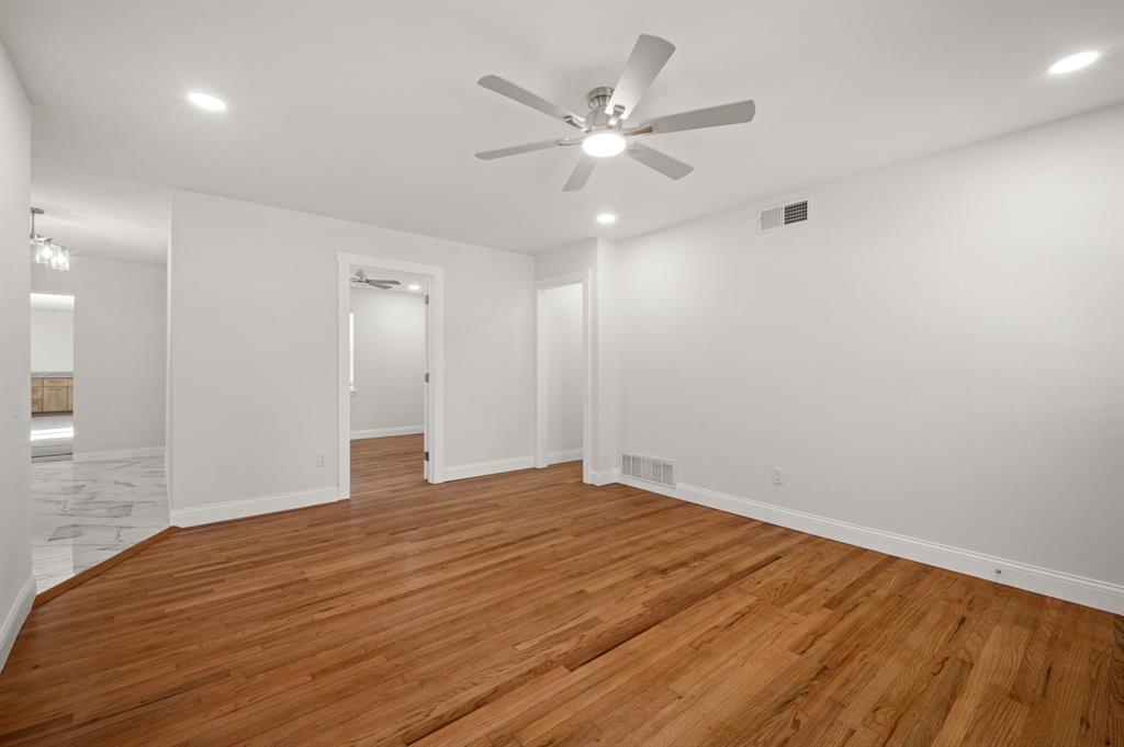Interior space featuring wood-finish flooring, a ceiling fan with integrated lighting, and recessed ceiling illumination