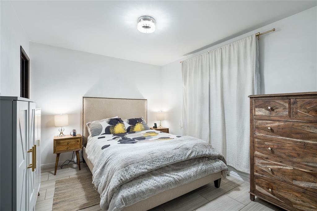 Neutral-toned space featuring light wood-finish flooring and a contemporary circular flush-mount ceiling light Neutral-toned space featuring light wood-finish flooring and a contemporary circular flush-mount ceiling light