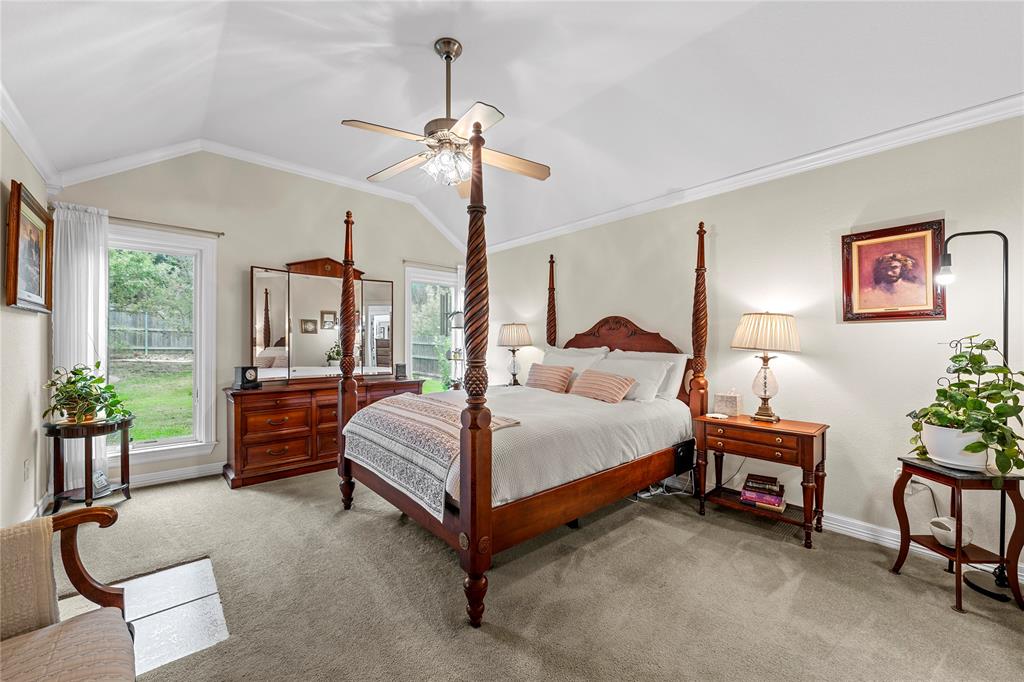 Vaulted ceiling featuring a central brushed-nickel ceiling fan with integrated light fixture and neutral wall-to-wall carpeting