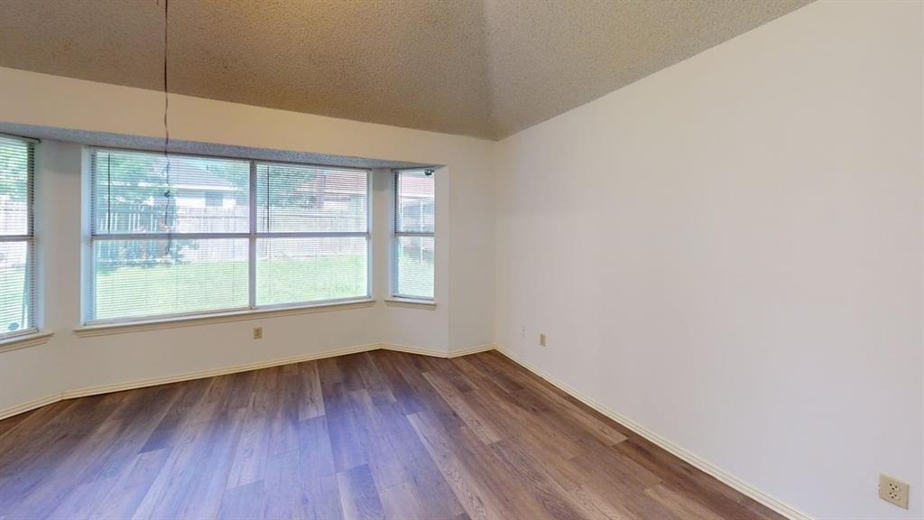 Vaulted ceiling, wood-finish flooring, and a large bay window configuration Vaulted ceiling, wood-finish flooring, and a large bay window configuration