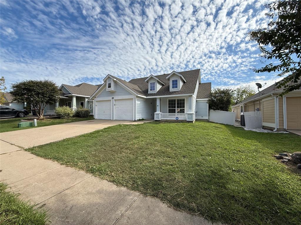 Exterior featuring light-toned horizontal siding, double-gable roofline with dormer windows, covered front porch, and a concrete driveway leading to a two-car garage Exterior featuring light-toned horizontal siding, double-gable roofline with dormer windows, covered front porch, and a concrete driveway leading to a two-car garage