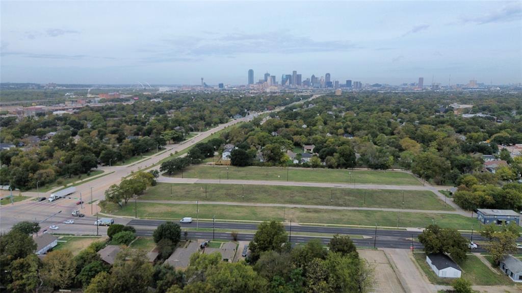 Expansive parcel of land featuring corner placement, proximity to major thoroughfares, and a skyline horizon
