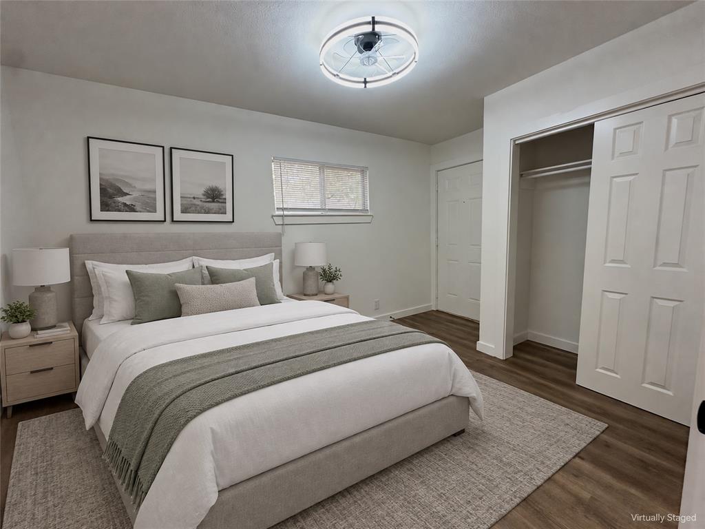 Wood-finish flooring, sliding closet doors, and a ceiling-mounted circular light fixture with integrated fan