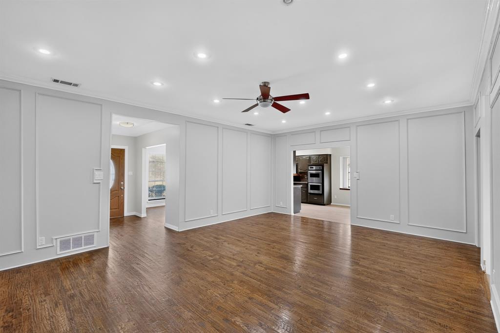 Hardwood flooring throughout, recessed lighting, and decorative wall paneling Hardwood flooring throughout, recessed lighting, and decorative wall paneling