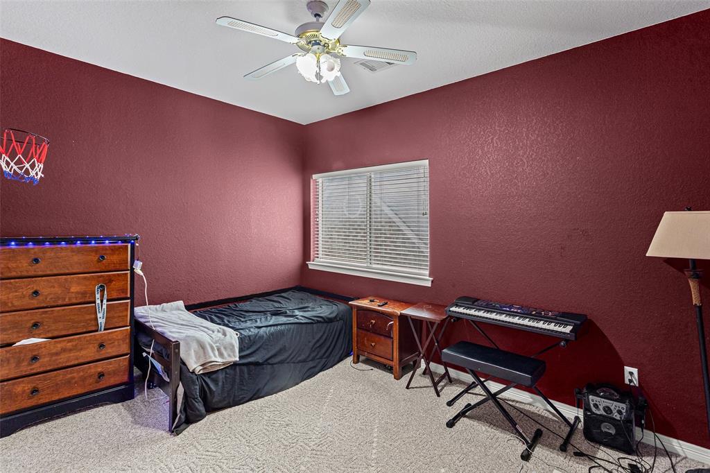 Textured walls, ceiling fan with integrated lighting, and horizontal window blinds