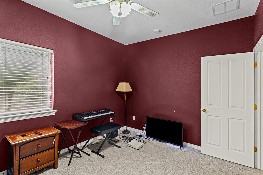 Room featuring neutral carpeting, a ceiling-mounted light fixture, and a four-panel interior door