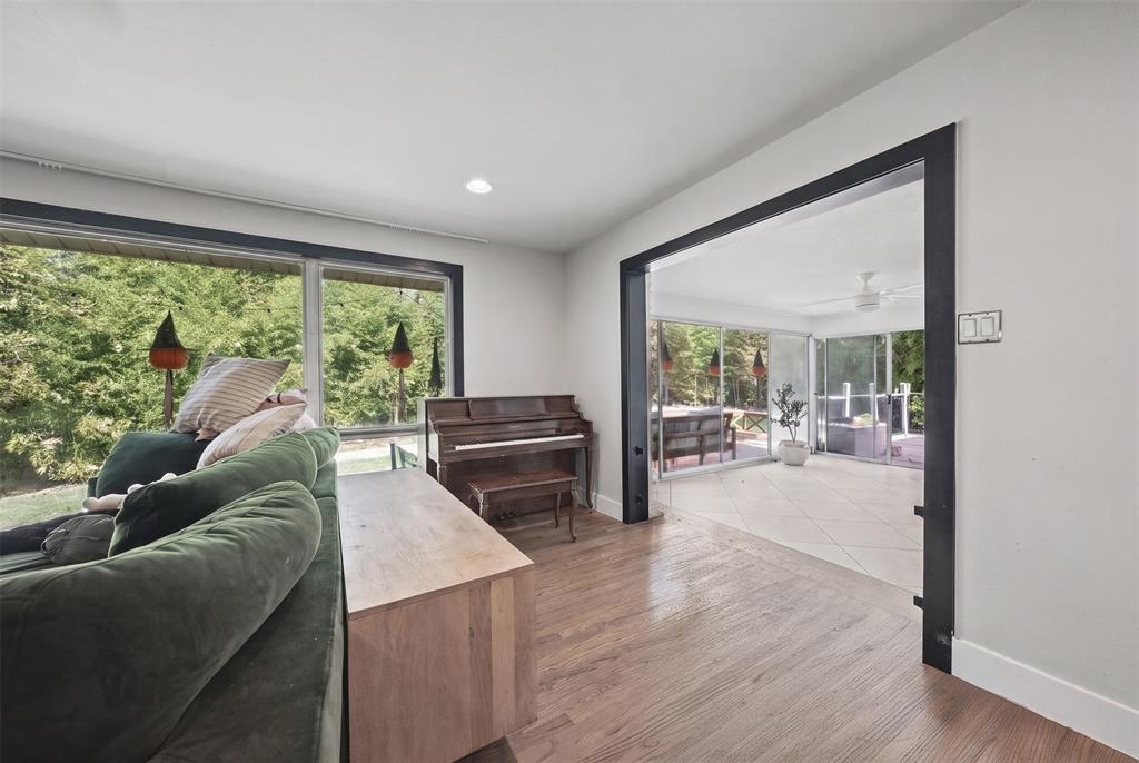 Interior featuring wood-finish flooring, recessed lighting, expansive picture windows, and large-scale entryways with dark-toned trim