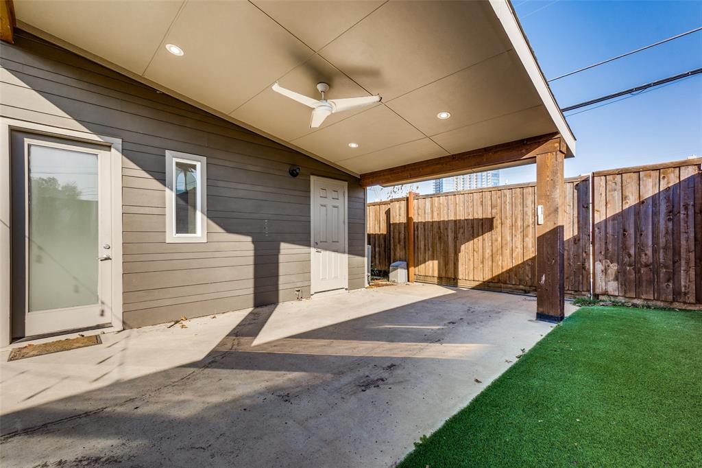 Covered patio featuring recessed lighting, a ceiling fan, horizontal siding, and synthetic turf lawn