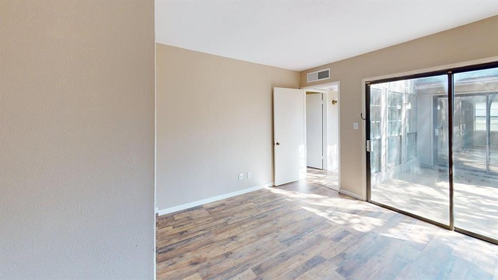 Neutral wall color, wood-finish flooring, and large sliding glass doors Neutral wall color, wood-finish flooring, and large sliding glass doors