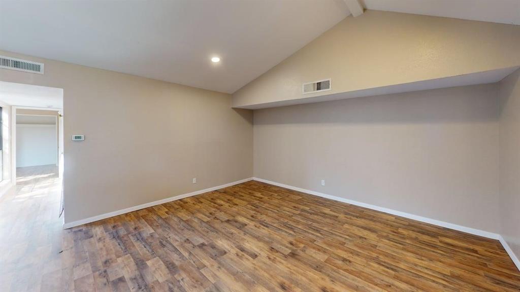 Vaulted ceiling, wood-finish flooring, and recessed lighting