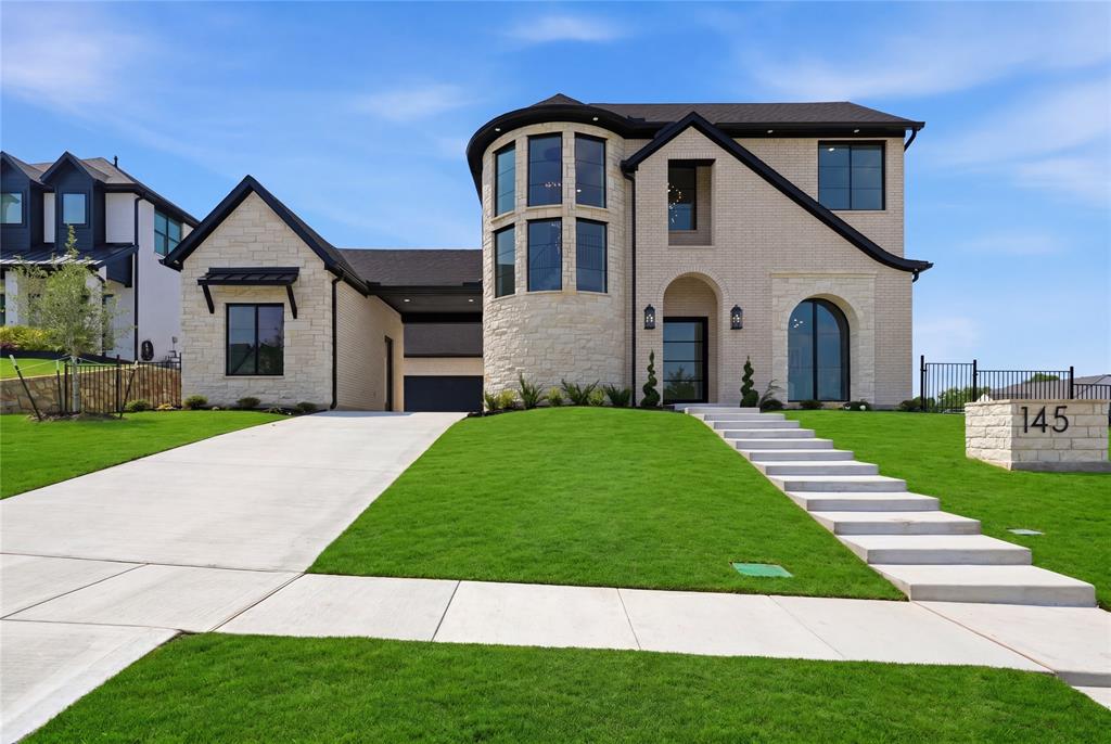 Contemporary-style residence featuring a prominent stone facade and a striking curved window tower