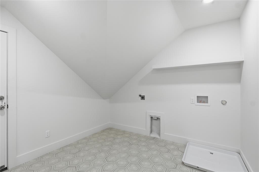 Laundry area featuring geometric patterned floor tiles, white baseboards, a utility sink rough-in, and a built-in shelf