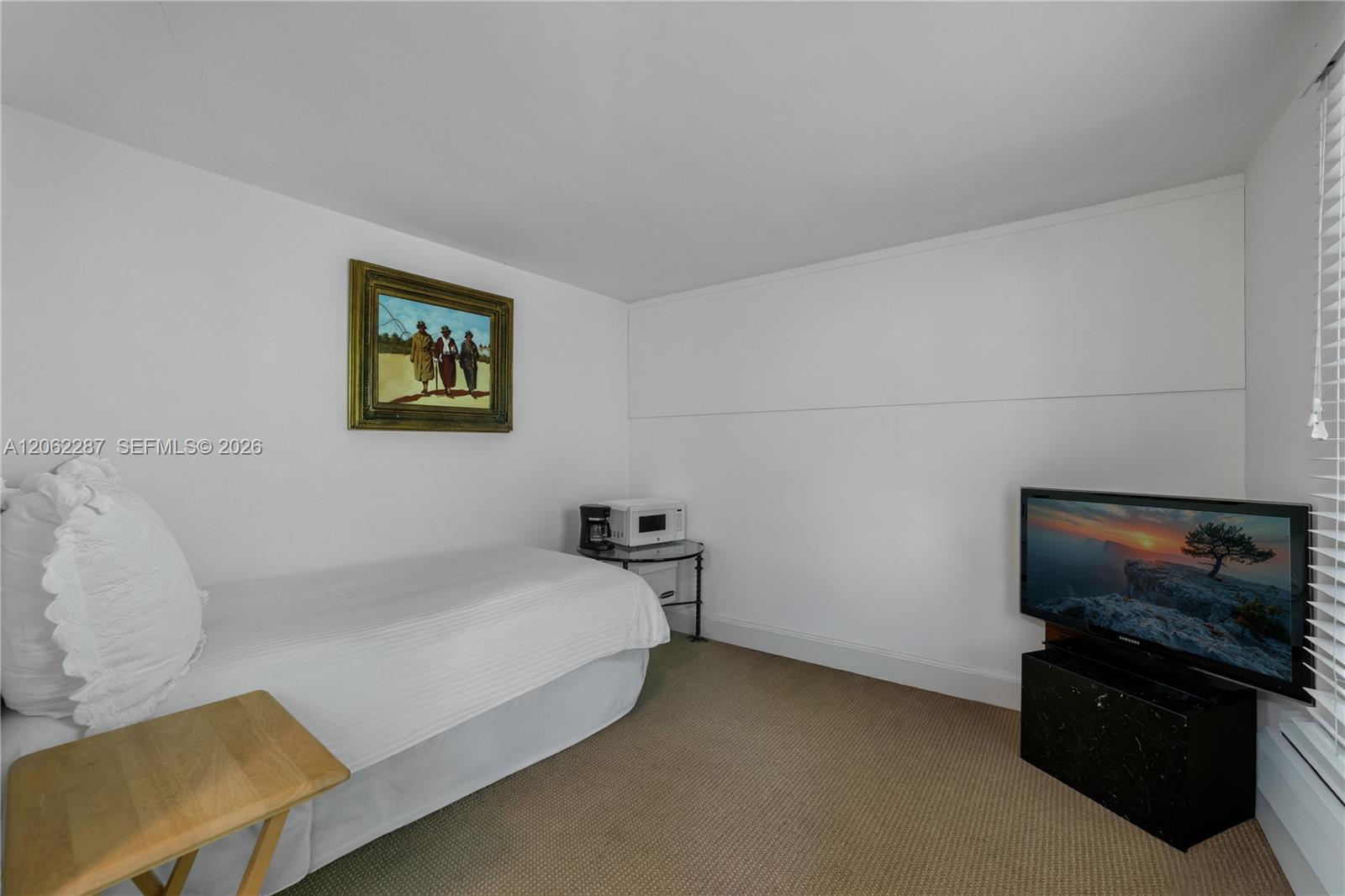 Staff Suite: Neutral-toned wall-to-wall carpeting and crisp white interior paint finish