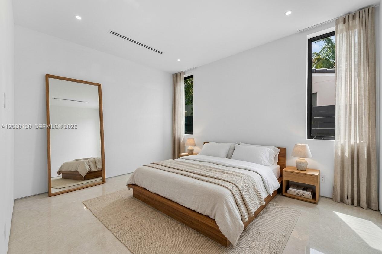 Guest Bedroom. Disclaimer: Several photographs presented in this listing contain digitally added furniture, artwork, and decor. These virtually staged images are intended solely for illustrative purposes.