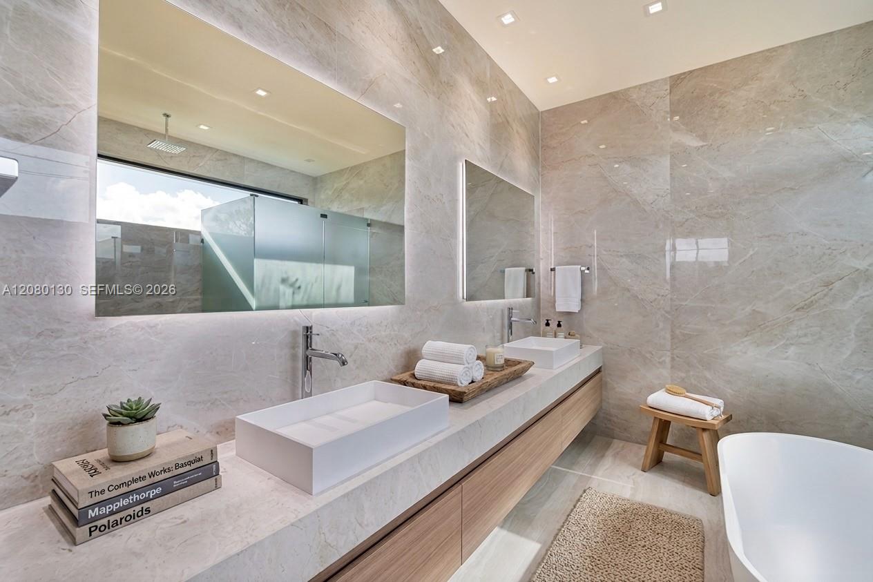 Primary Bathroom. Disclaimer: Several photographs presented in this listing contain digitally added furniture, artwork, and decor. These virtually staged images are intended solely for illustrative purposes.