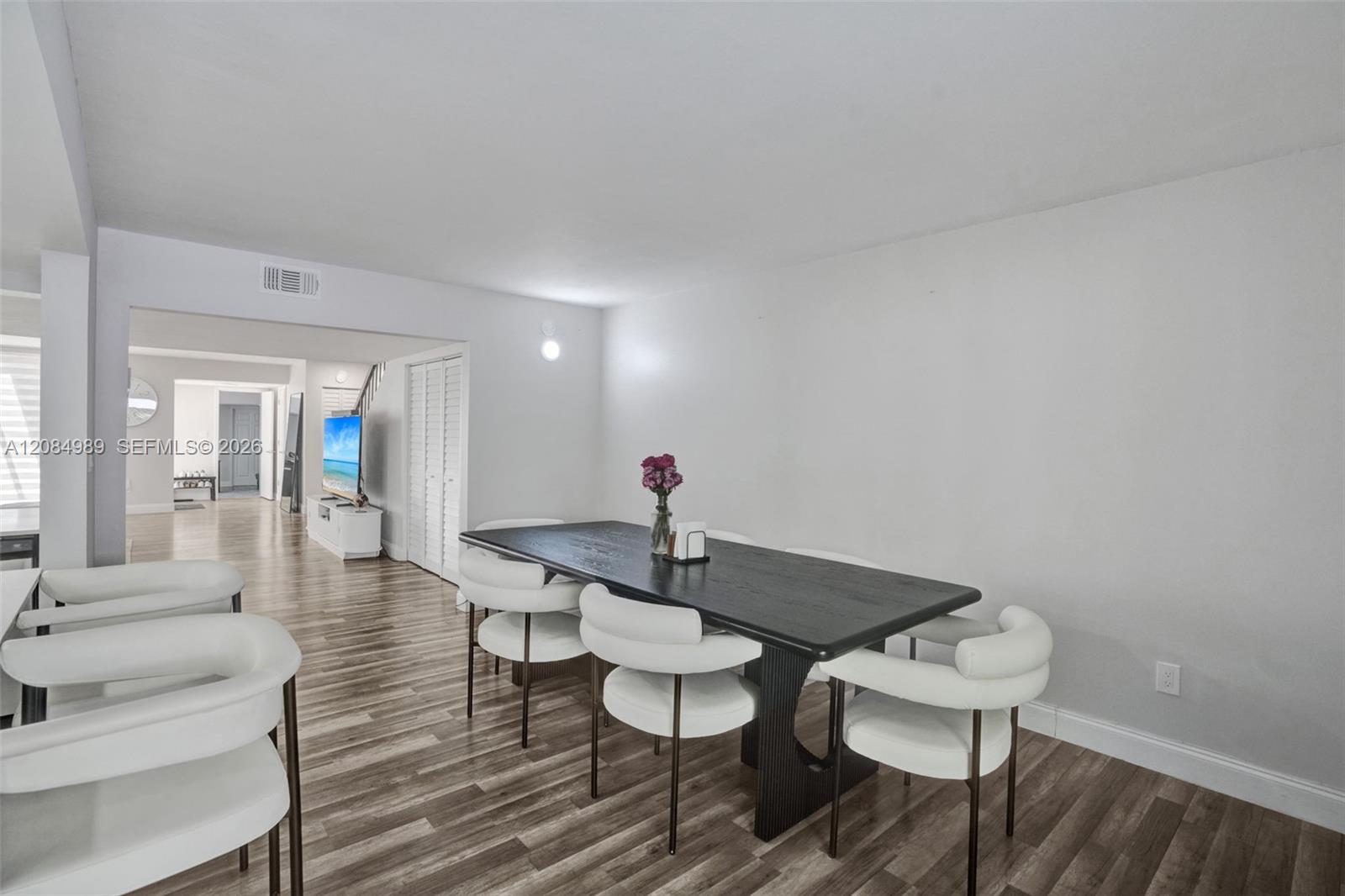 Neutral interior space featuring wood-finish flooring and bi-fold closet doors