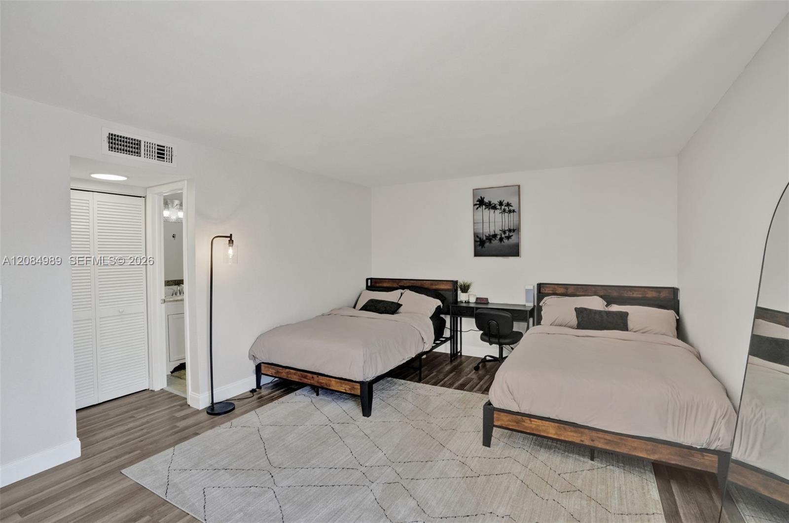 Room featuring wood-finish flooring and a double-door closet