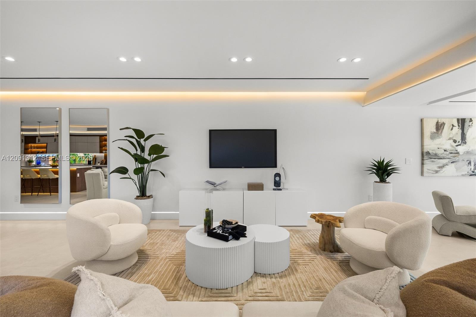 Modern interior featuring recessed lighting, cove ceiling accents, smooth wall finishes, and integrated custom cabinetry