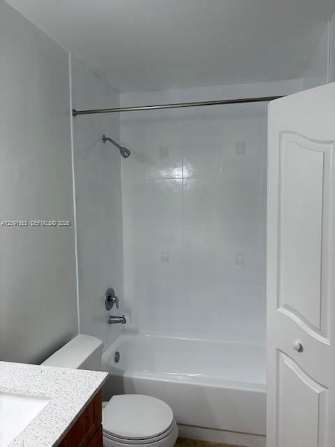Full-height white tile shower surround, chrome shower fixtures, built-in tub, white vanity with stone-composite countertop, and a six-panel door