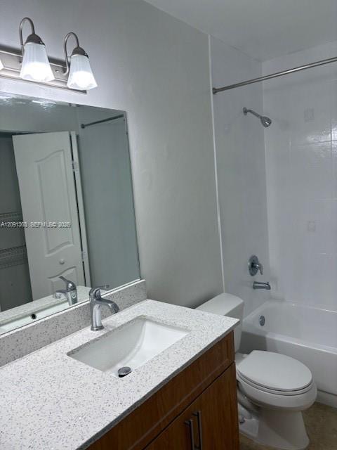 Bathroom featuring a vanity with stone-composite countertop, integrated rectangular sink, wood-finish cabinetry, dual-light wall sconce, and a shower-tub combination with white tile surround
