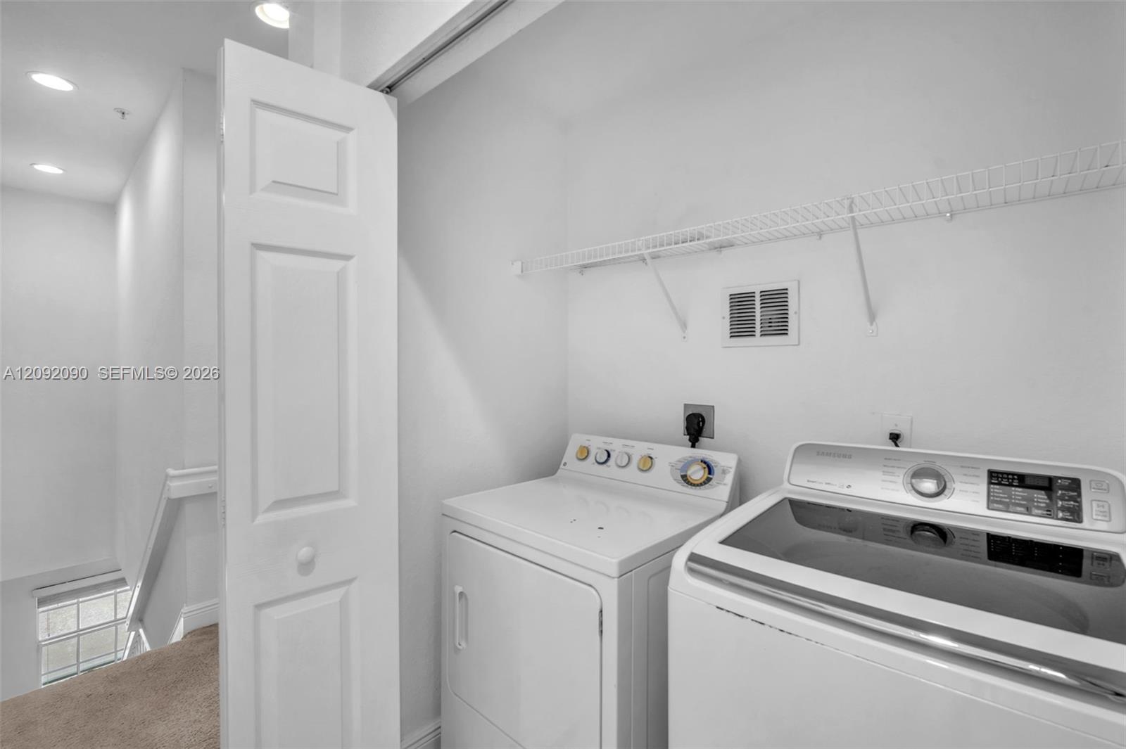 Laundry closet featuring a bi-fold door and wire shelving