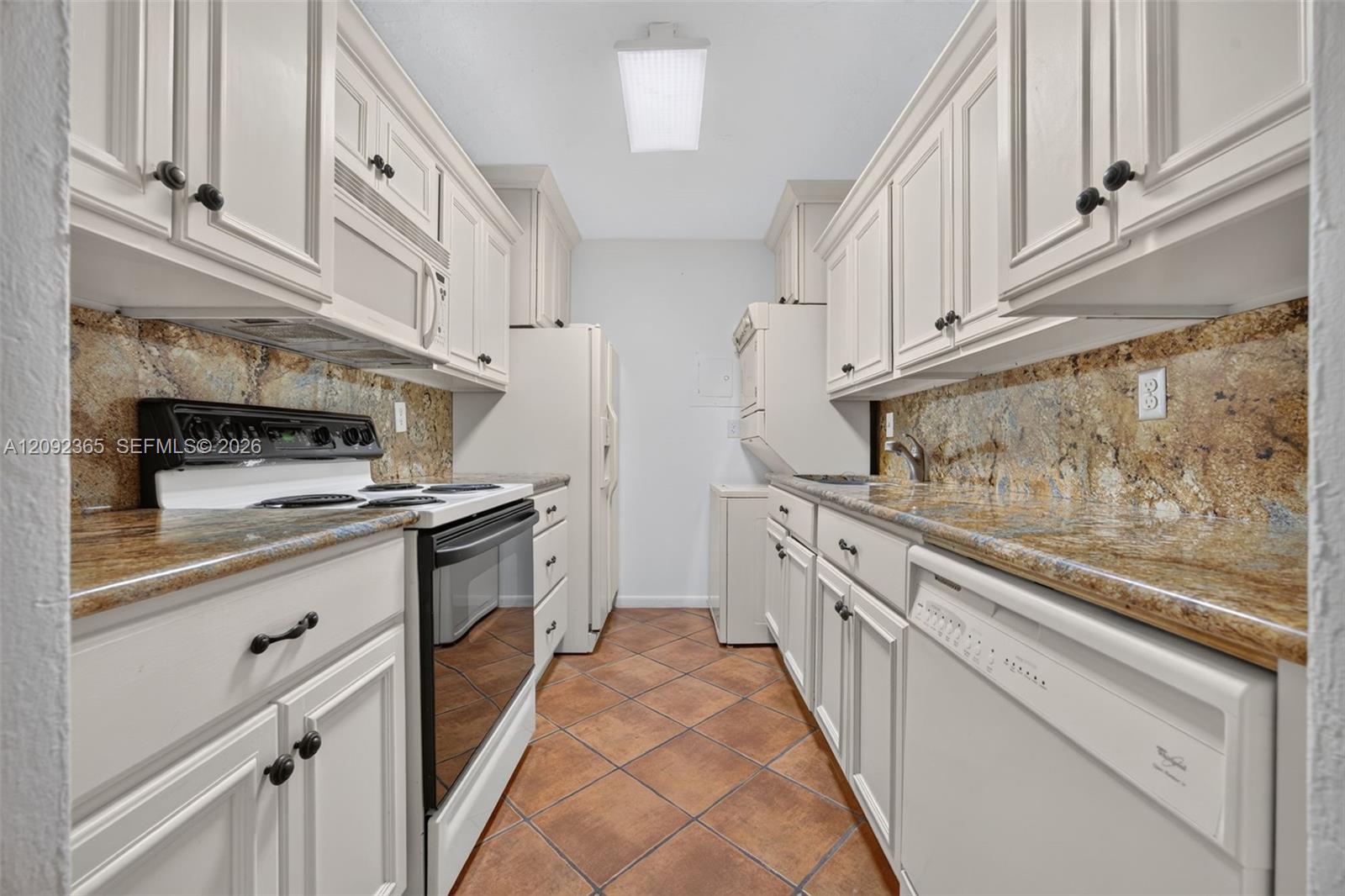 Kitchen with wood cabinetry, granite countertops & WASHER DRYER