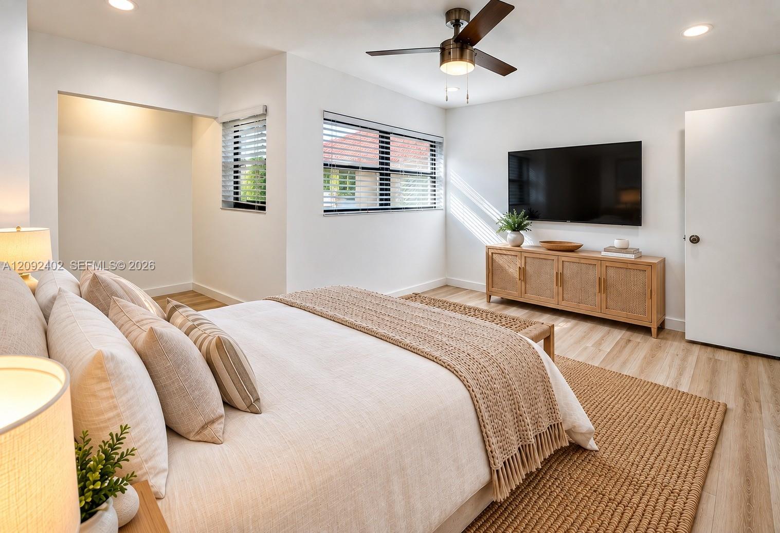 TV console & plants virtually staged for illustrative purposes. Interior space featuring wood-finish flooring, recessed lighting, and a ceiling fan with integrated light fixture