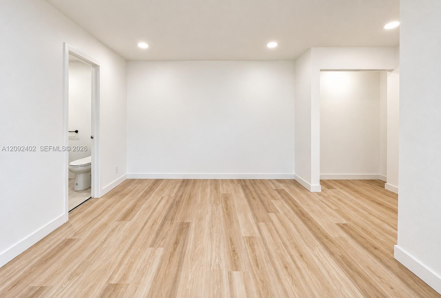 Interior space featuring wood-finish flooring, recessed lighting, and neutral wall paint